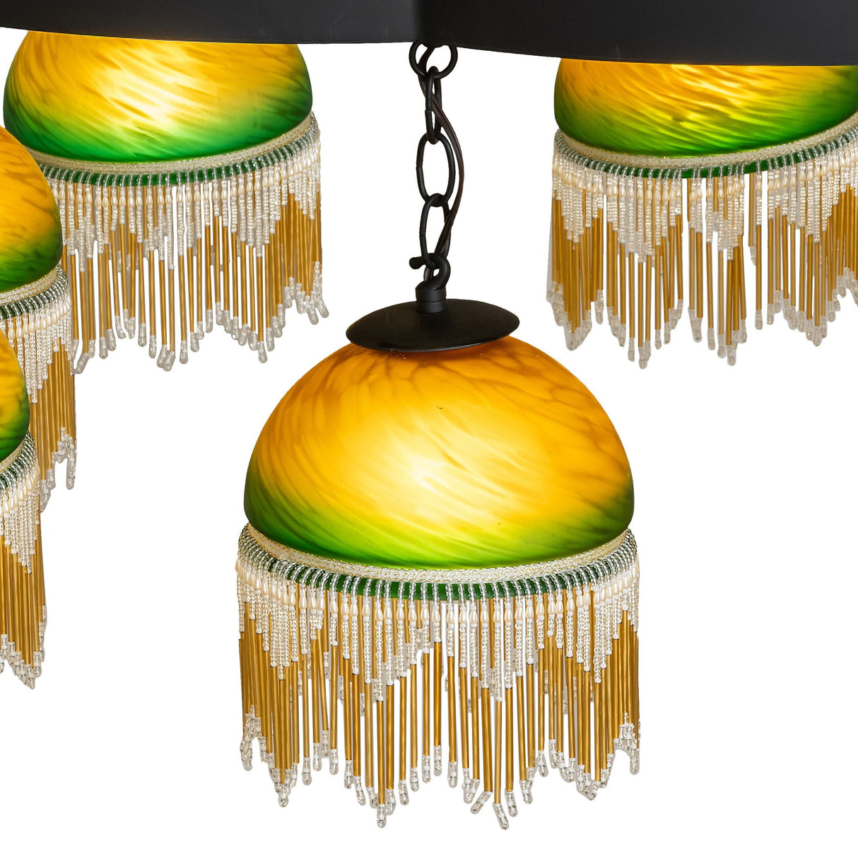 Close-up of green and amber glass shade with fringe detail.