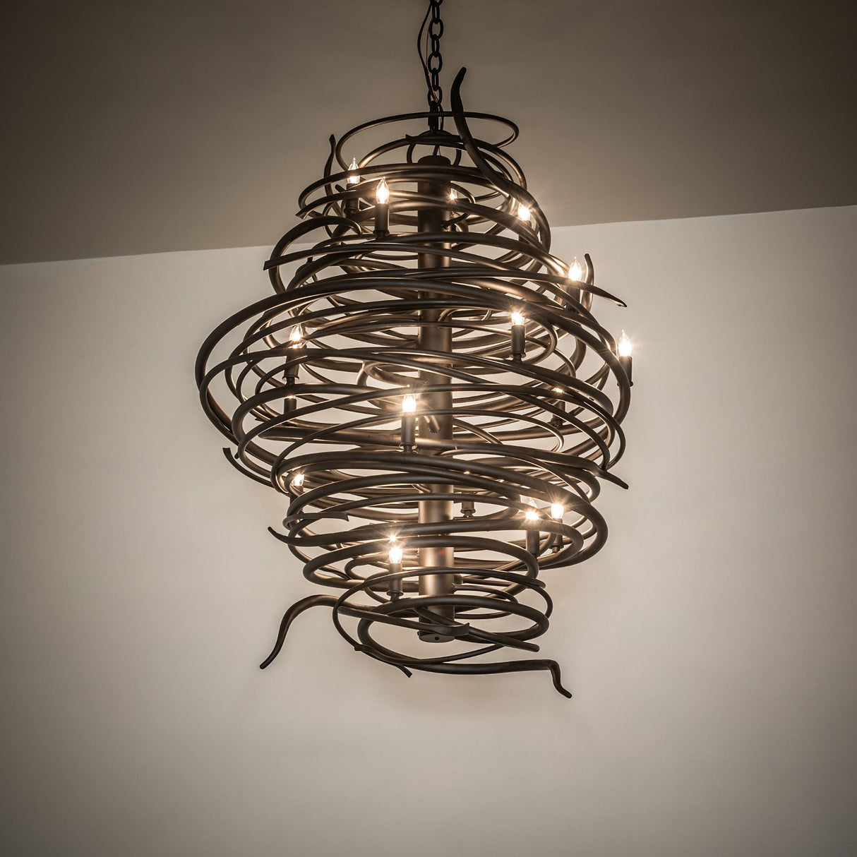 Cyclone 20 light chandelier illuminated in room setting ambient view.