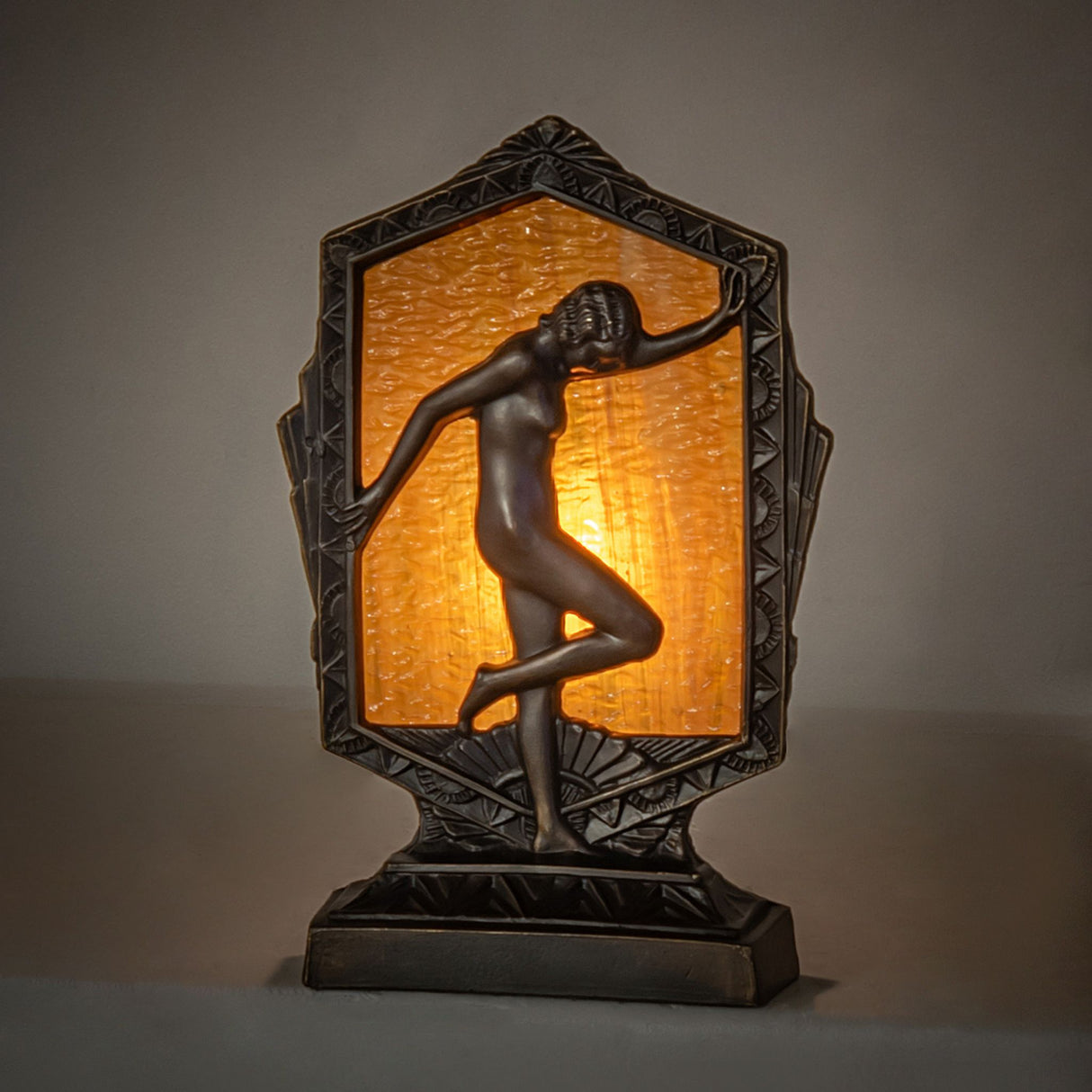 Art Deco-style accent lamp featuring a gracefully posed lady against a Honey Granite Glass backdrop.