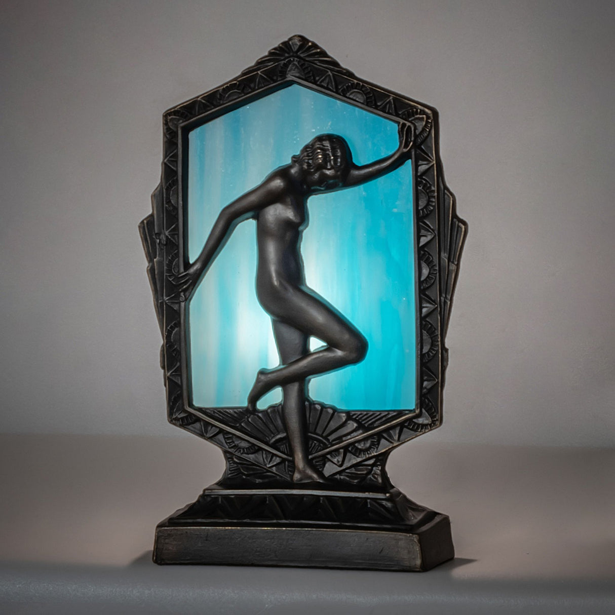 Ambient view of the Deco Posing Lady Accent Lamp showcasing Sky Blue Art Glass.