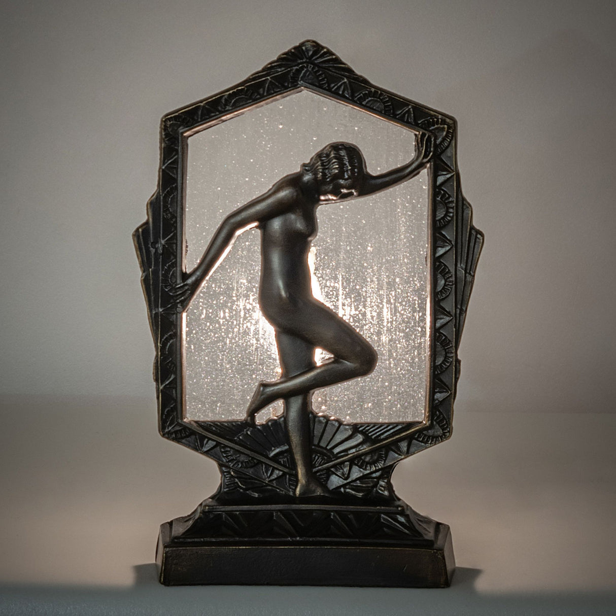 Deco Posing Lady Accent Lamp with an elegant metal frame and illuminated clear seeded glass.