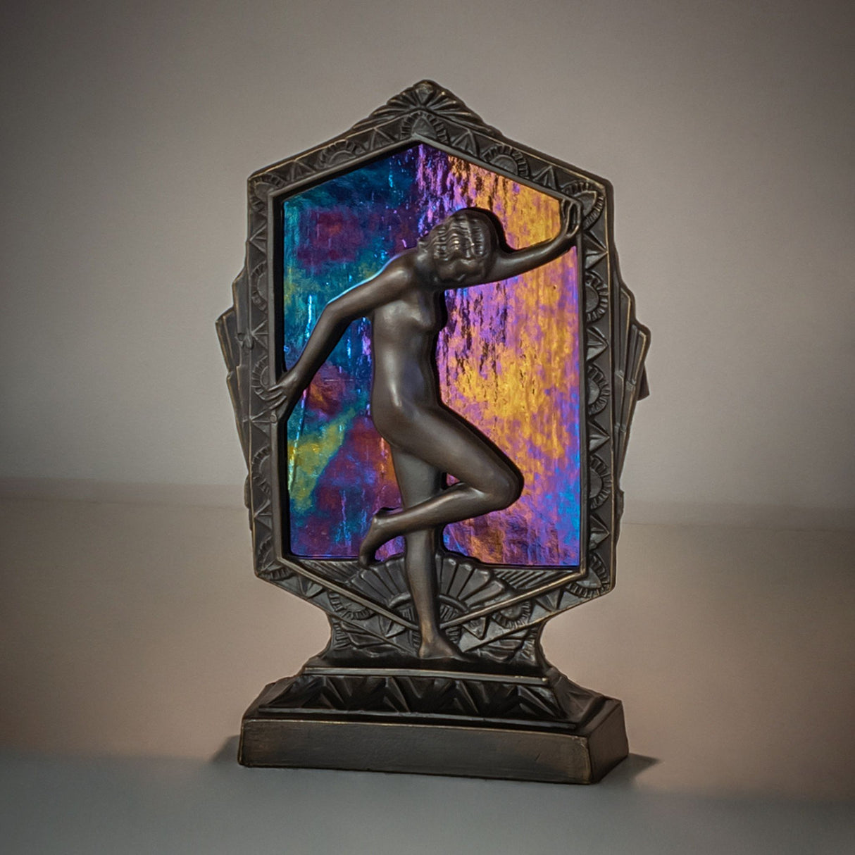 Illuminated Deco Posing Lady accent lamp with Black Iridescent Glass casting a dramatic glow.