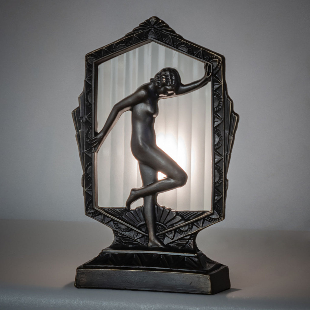 Illuminated Deco Posing Lady Accent Lamp with frosted fluted glass creating a soft glow.