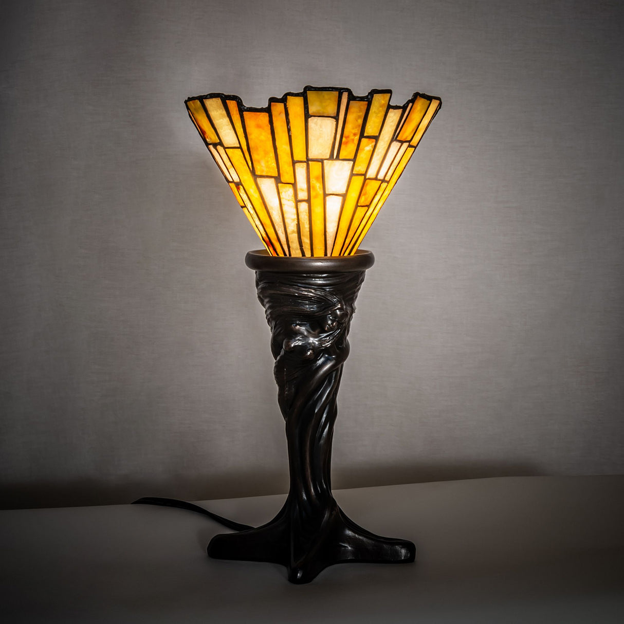 Delta Jadestone Mini Lamp illuminated in a dimly lit setting, showcasing its warm glow.