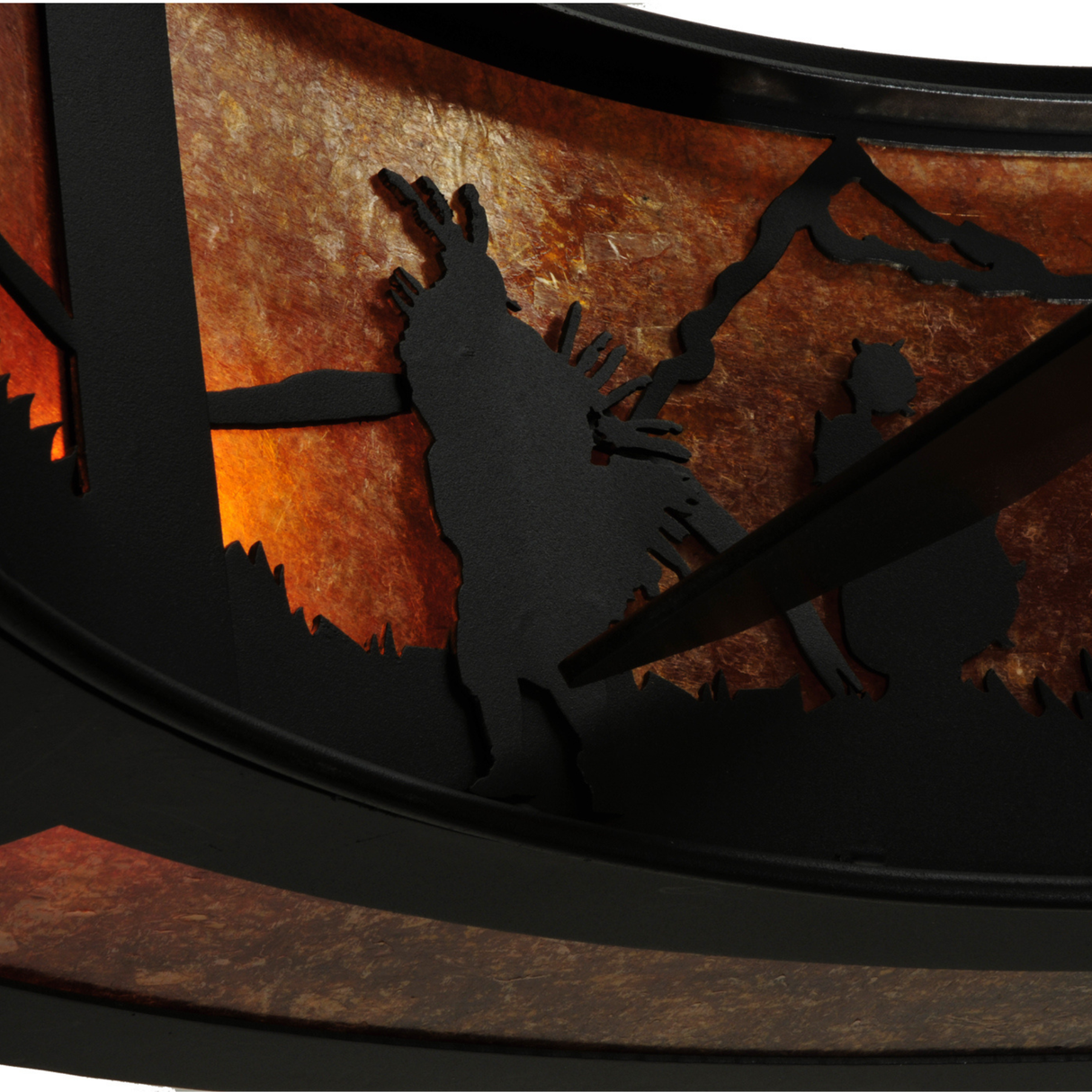 Detail view of horse and rider design with desert mountain backdrop.