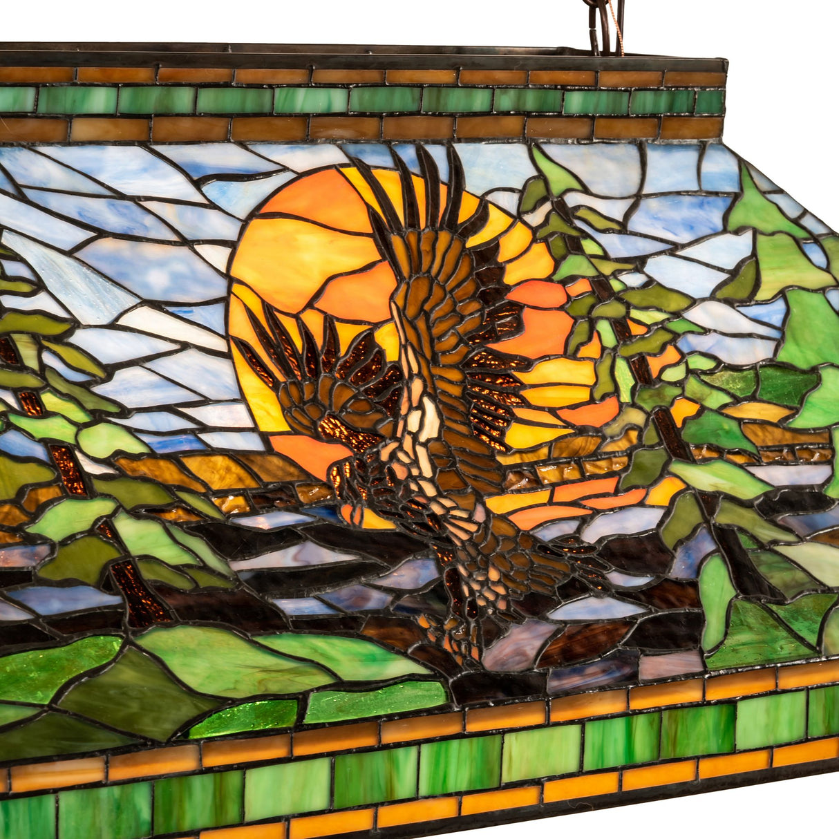 Close-up of the Eagle at Sunset pendant showing detailed art glass with a vivid eagle and sun.