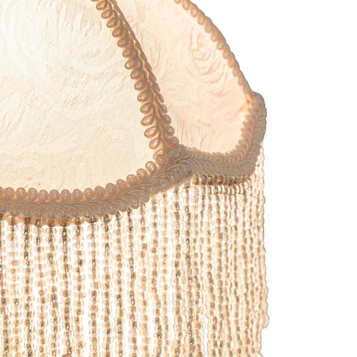 Close-up view emphasizing the detailed embroidery and shimmering ivory beaded fringe.