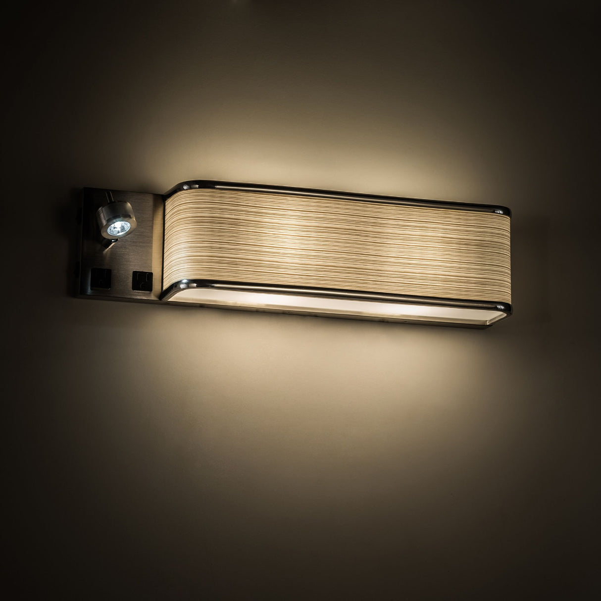 Finley sconce illuminated against a wall for soft lighting.