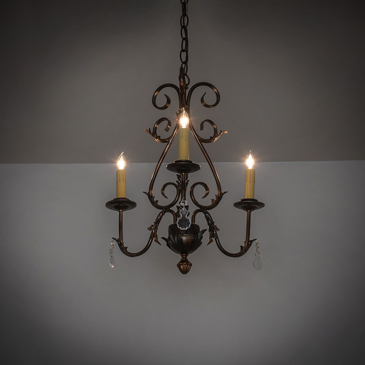 French Elegance 3-light chandelier lit in a dark room setting showing warm ambient glow.