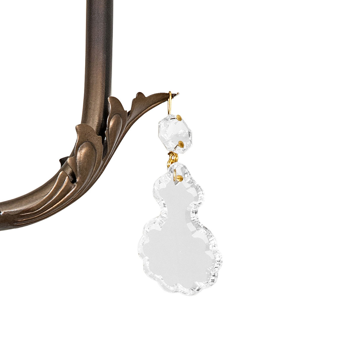 Close-up of hanging crystal ornament on the French Elegance chandelier arm.