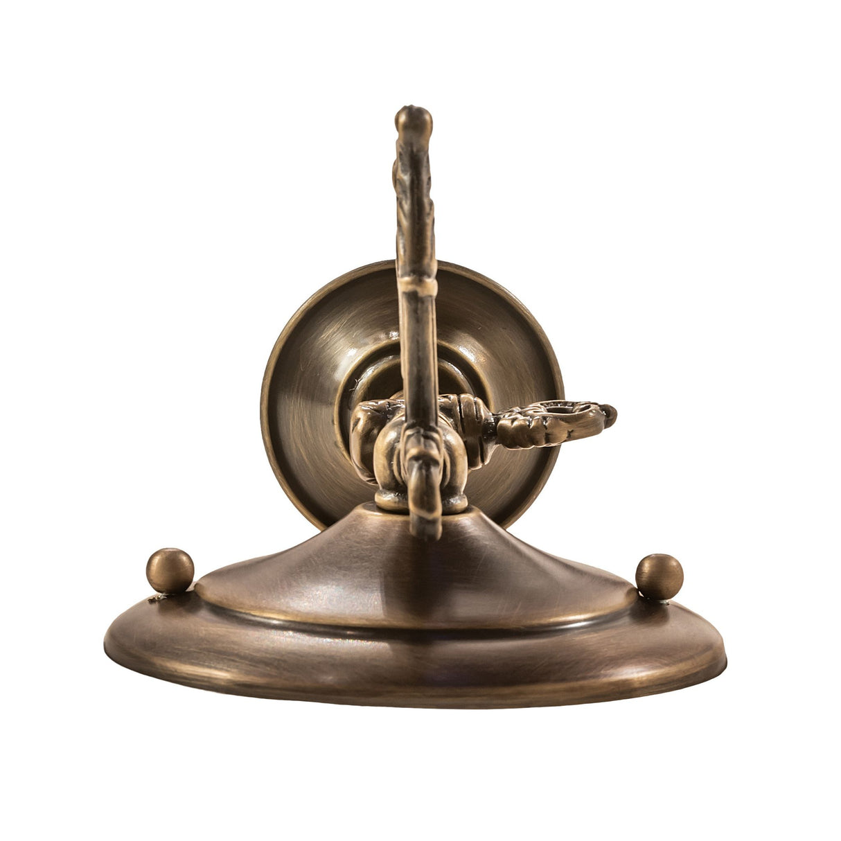 Ornate scroll arm detail on antique brass wall sconce.