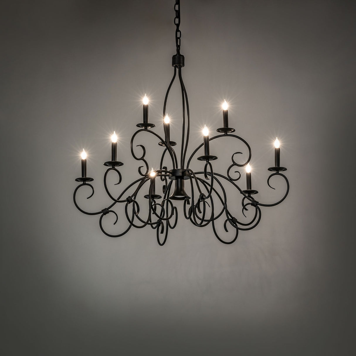 Grace chandelier illuminated with candle-style lights.