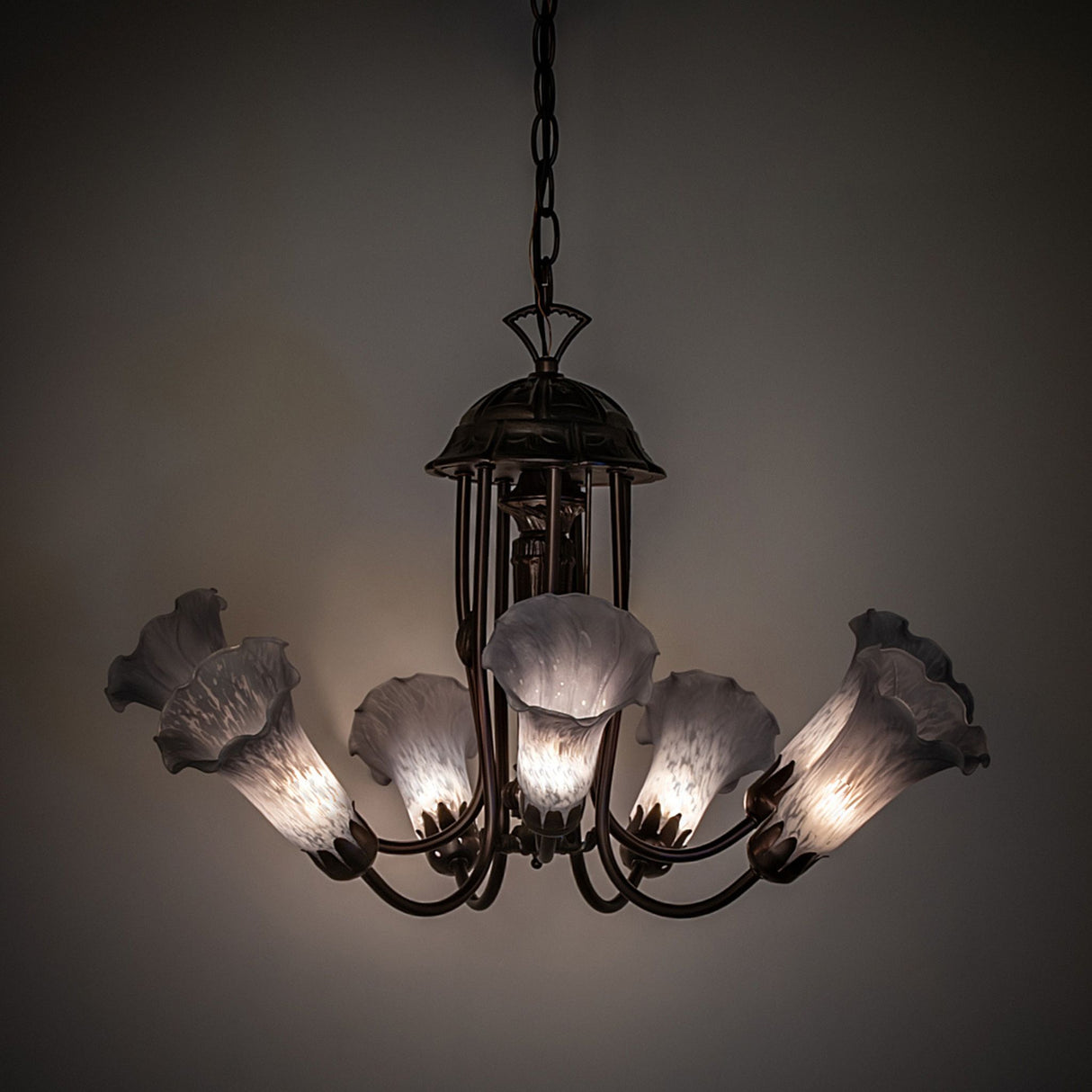 Softly illuminated gray Tiffany pond lily chandelier.