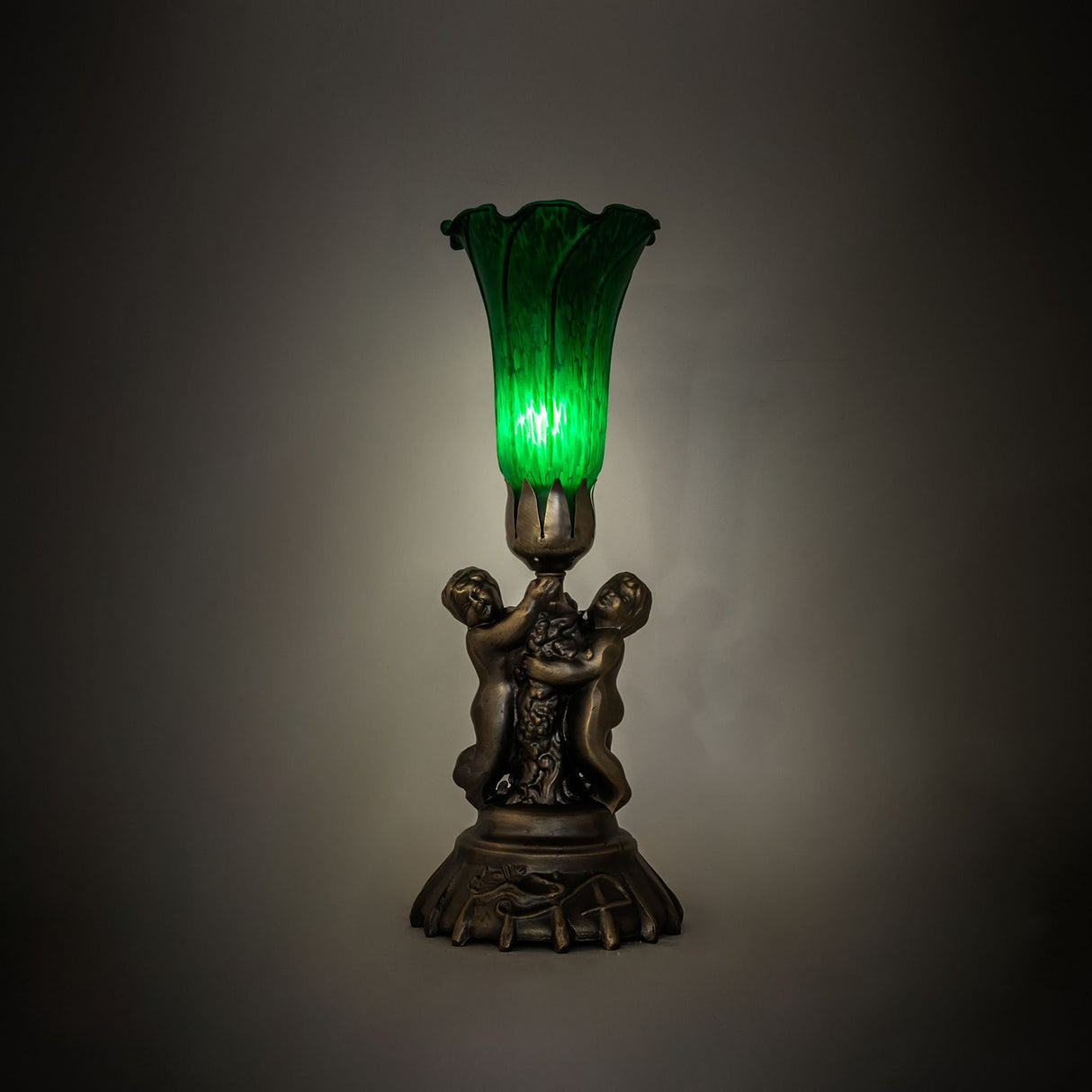 Illuminated view of the Green Tiffany Pond Lily lamp glowing with fine green art glass.