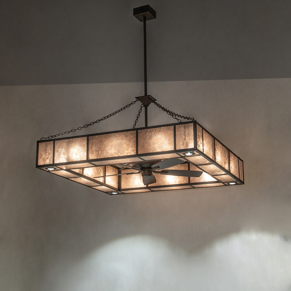 Large Hausman chandelier fan glowing warmly in a modern interior.