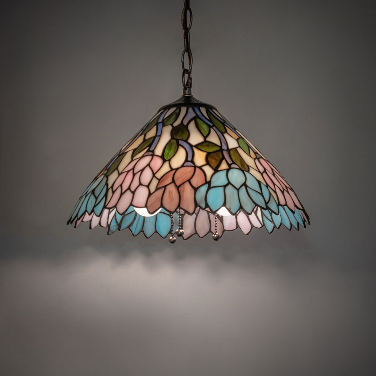Illuminated Wisteria pendant with colorful glass pattern.