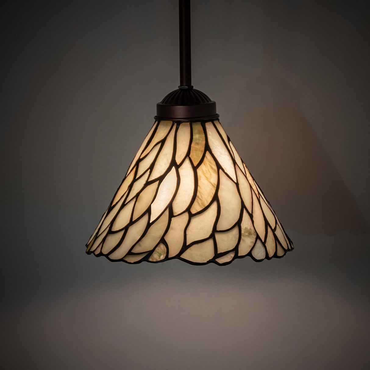 Illuminated jadestone mini pendant showcasing soft green and ivory glow.