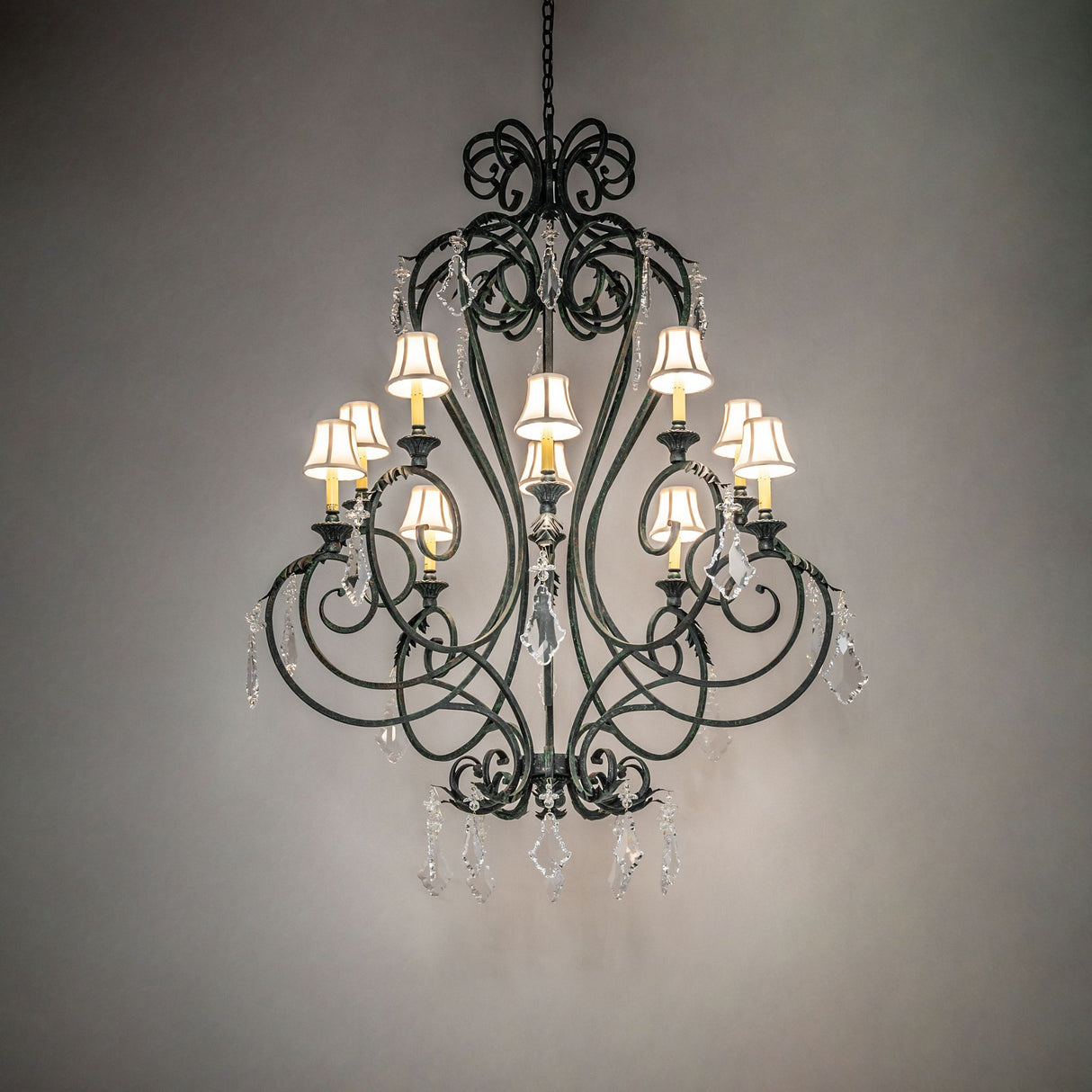 Josephine chandelier casting warm ambient light with fabric shades and crystals.
