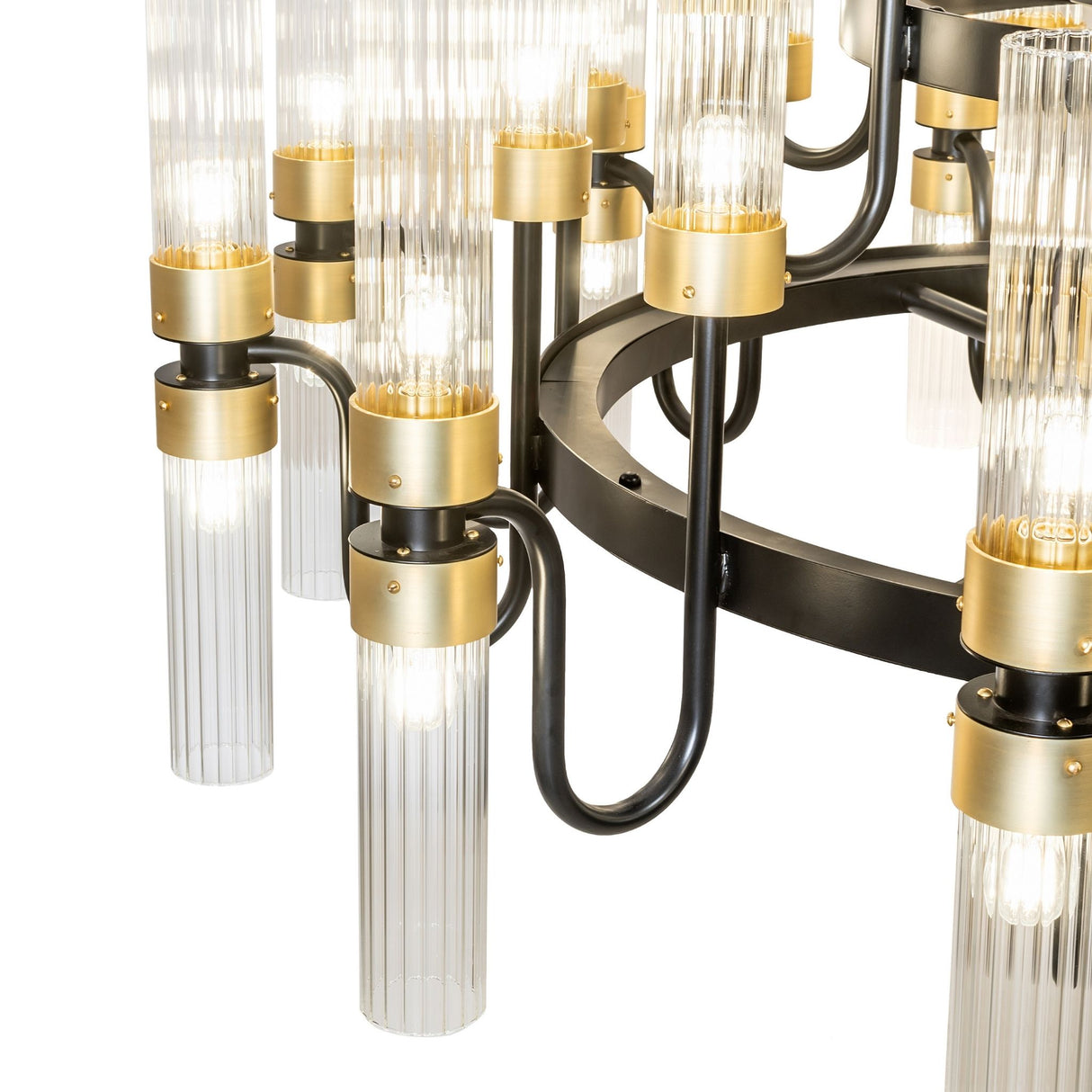 Closeup of Kahler chandelier arms with brass accents and glass tubes.