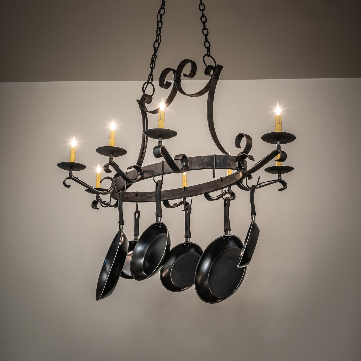 Laramie 8 light pot rack chandelier glowing with warm illumination.