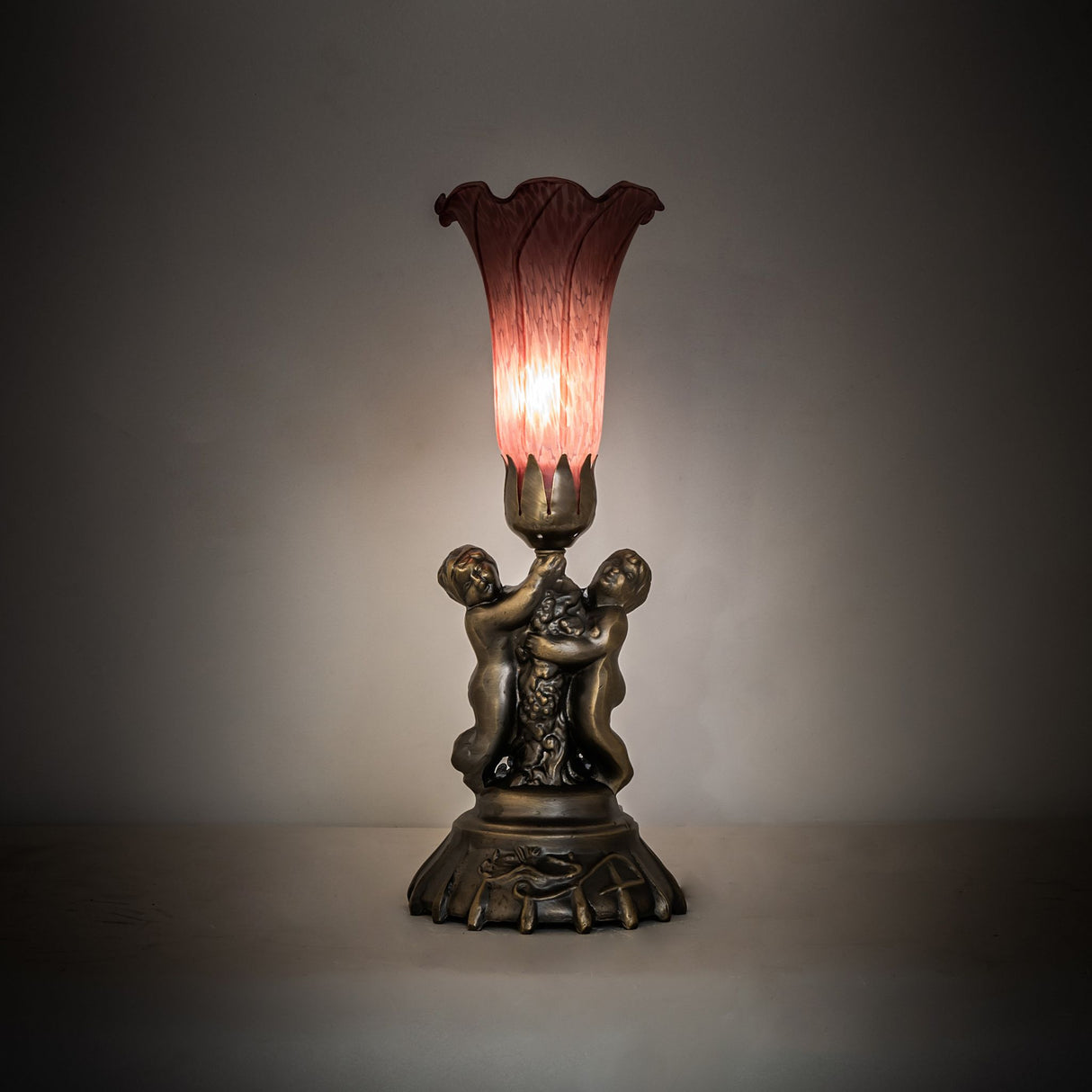 Lavender Pond Lily twin cherub mini lamp in ambient lighting.