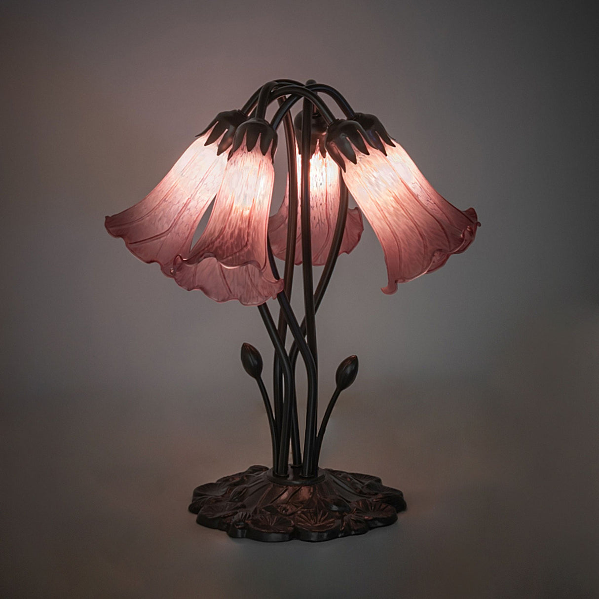Illuminated lavender pond lily table lamp with artistic glass shades.