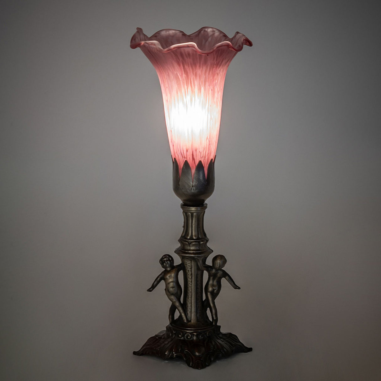 Ambient view of the Lavender Tiffany Pond Lily Maidens Mini Lamp glowing softly.