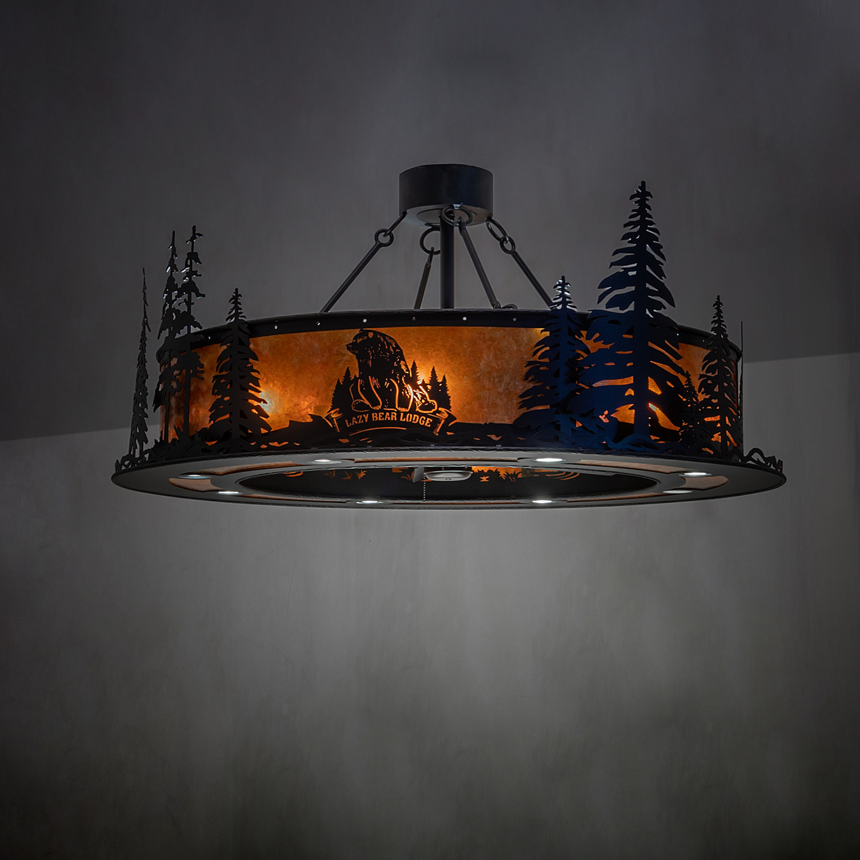 Angled lit view highlighting pine tree silhouettes and warm amber light.