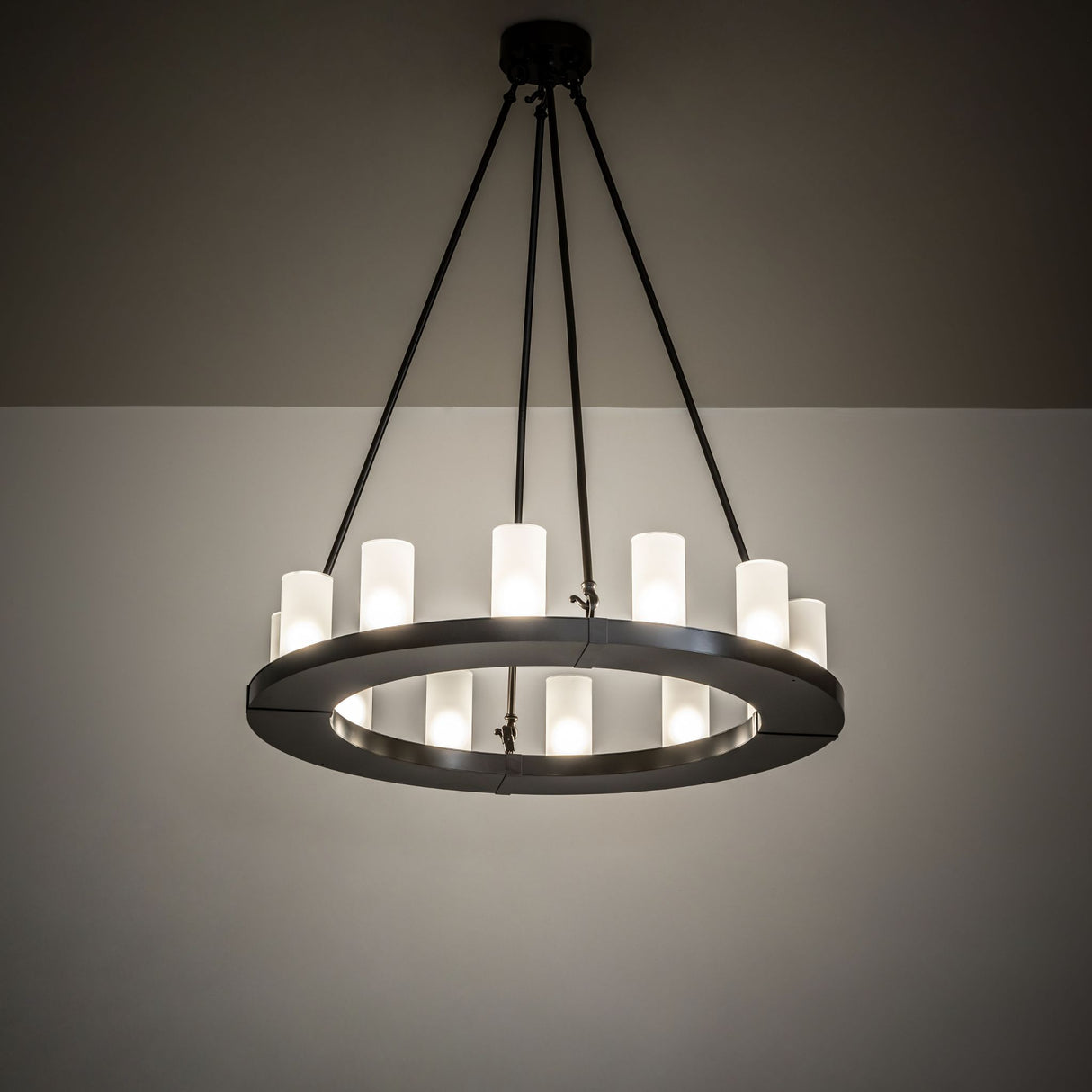 Ambient view of the chandelier, illuminated in a dark room setting.