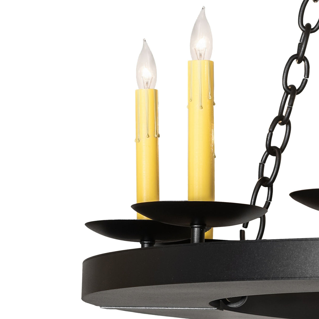 Closeup of ivory faux candlelights and black metal bobeche plates.