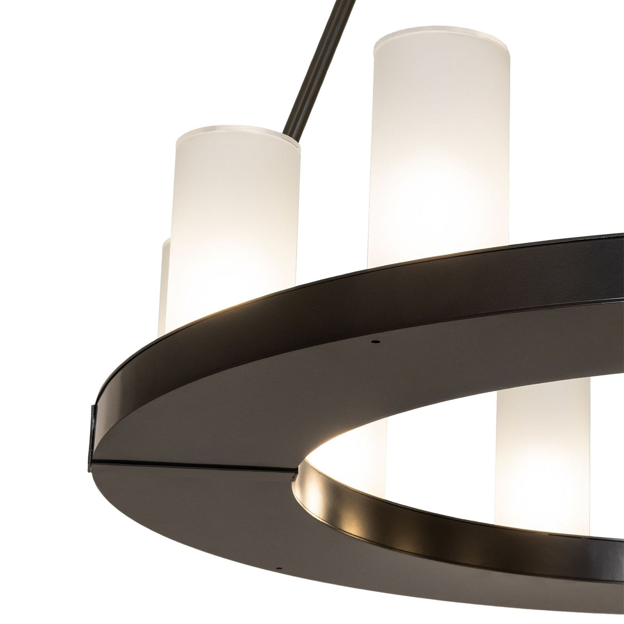 Close up of the chandelier showing the circular ring and frosted glass cylinder shades.