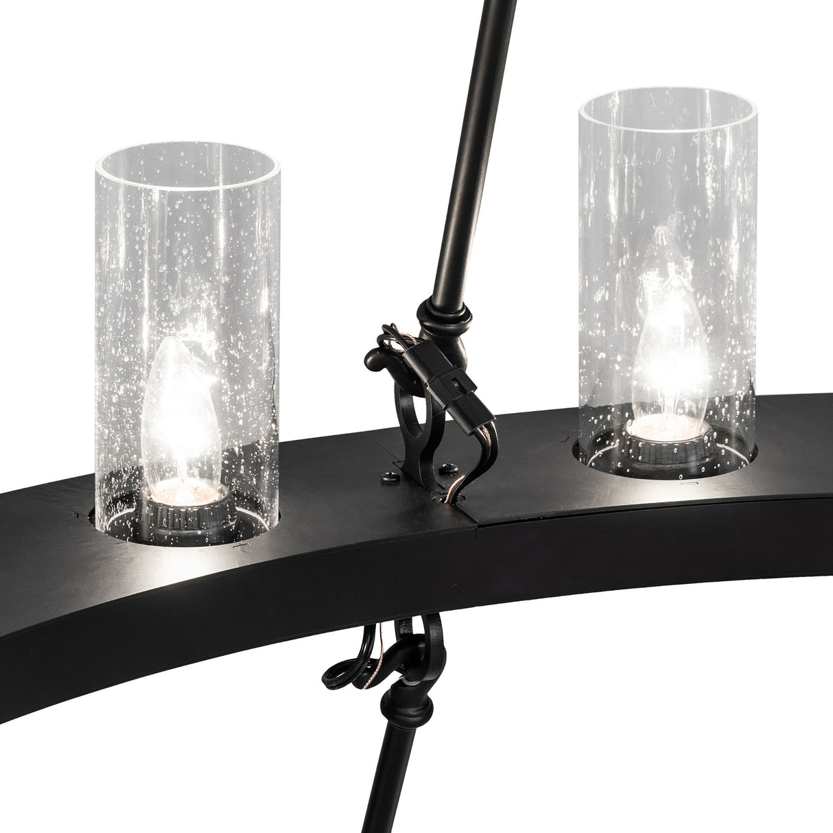 Close-up of seeded glass cylinders and mounting hardware on chandelier.
