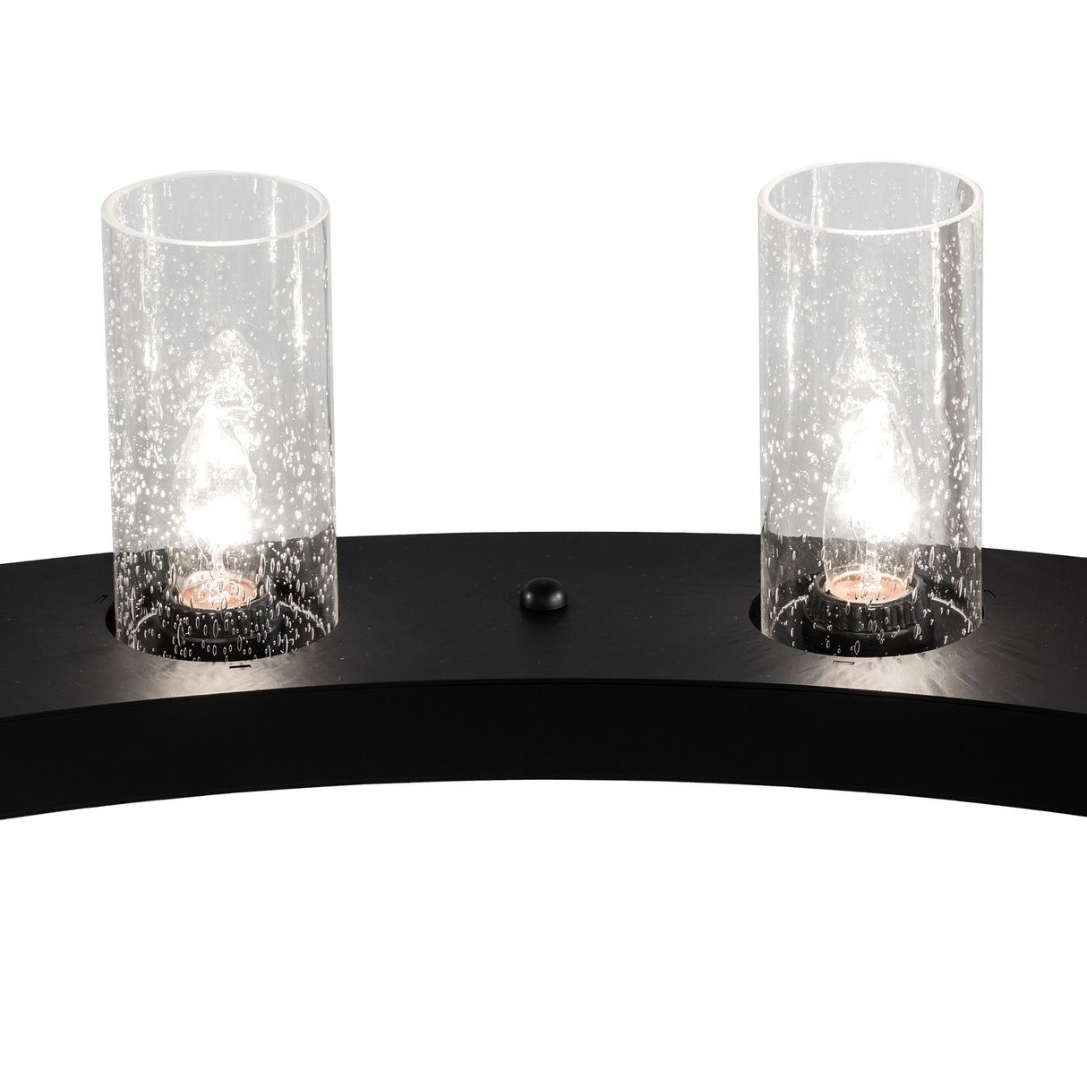 Close-up of illuminated seeded glass light on chandelier.