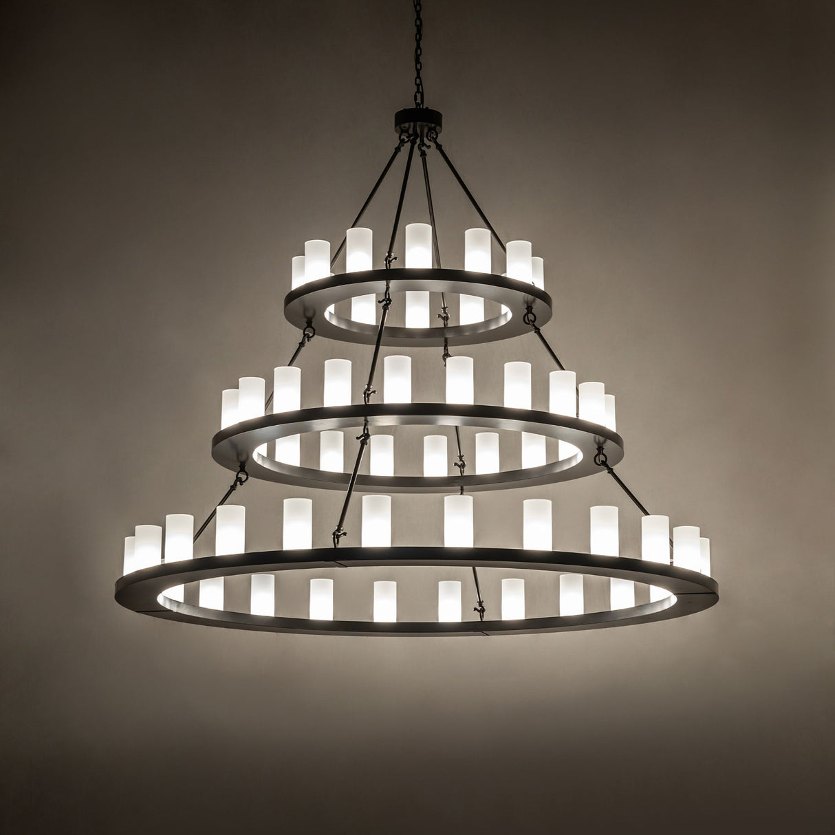 Loxley three-tier chandelier creating soft ambient lighting in a modern interior.