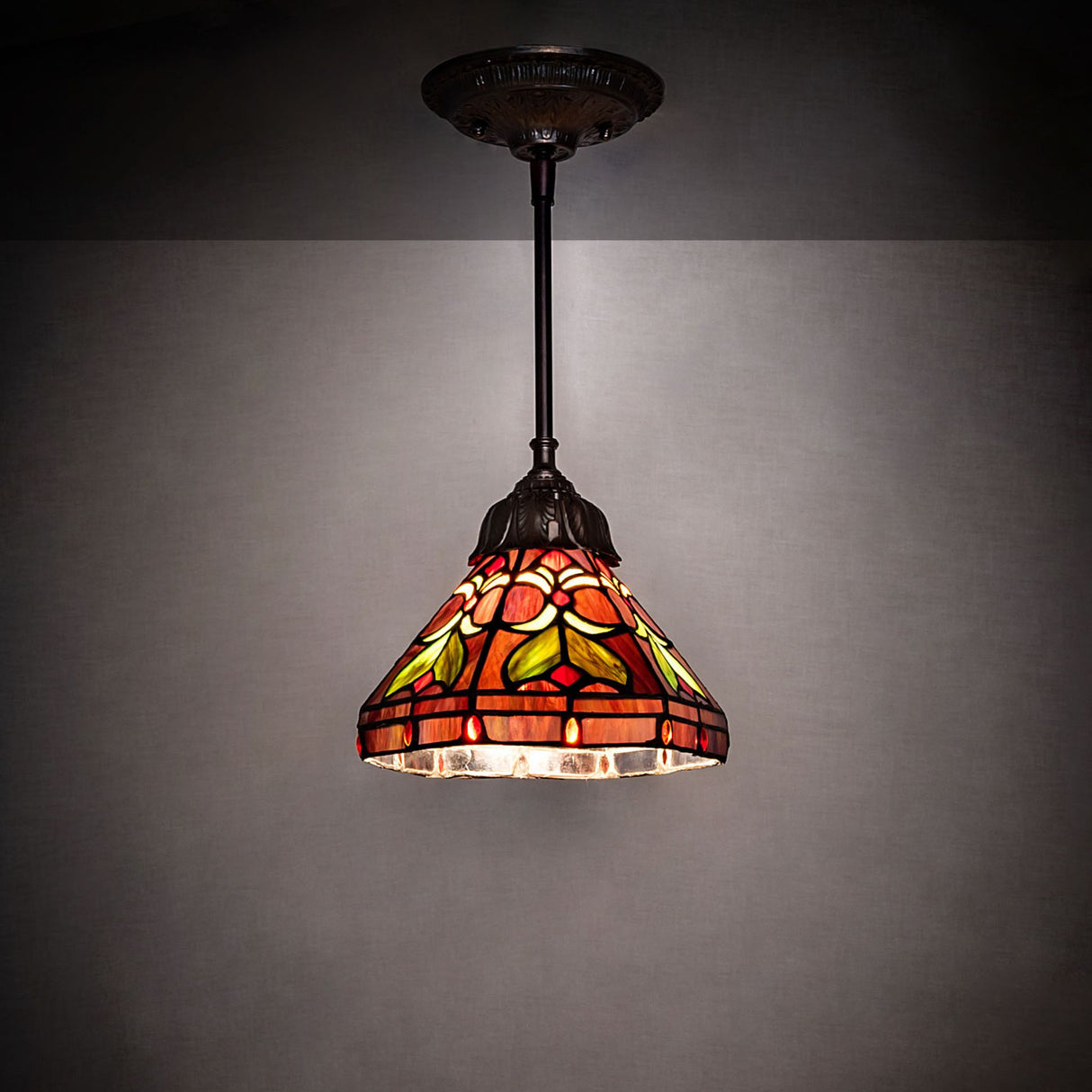 Illuminated Middleton mini pendant highlighting its intricate glass pattern.