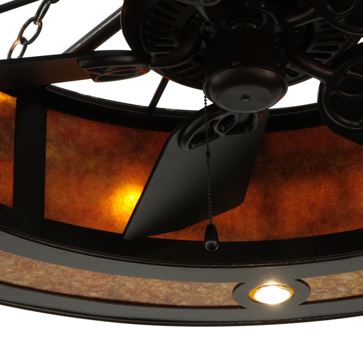 Close-up of inner fan blades and illuminated amber shade.