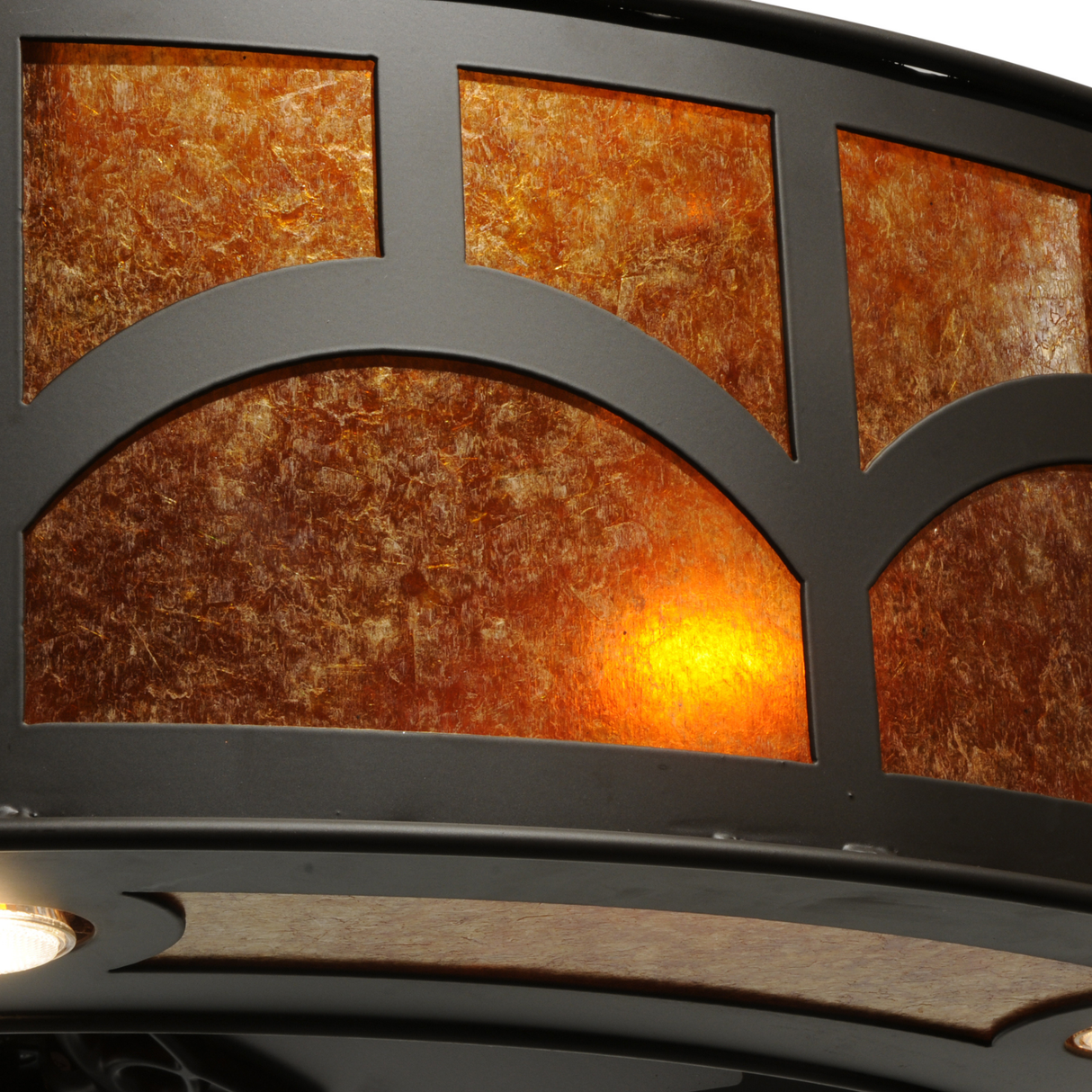 Close-up of glowing amber mica panels and metal grid design.