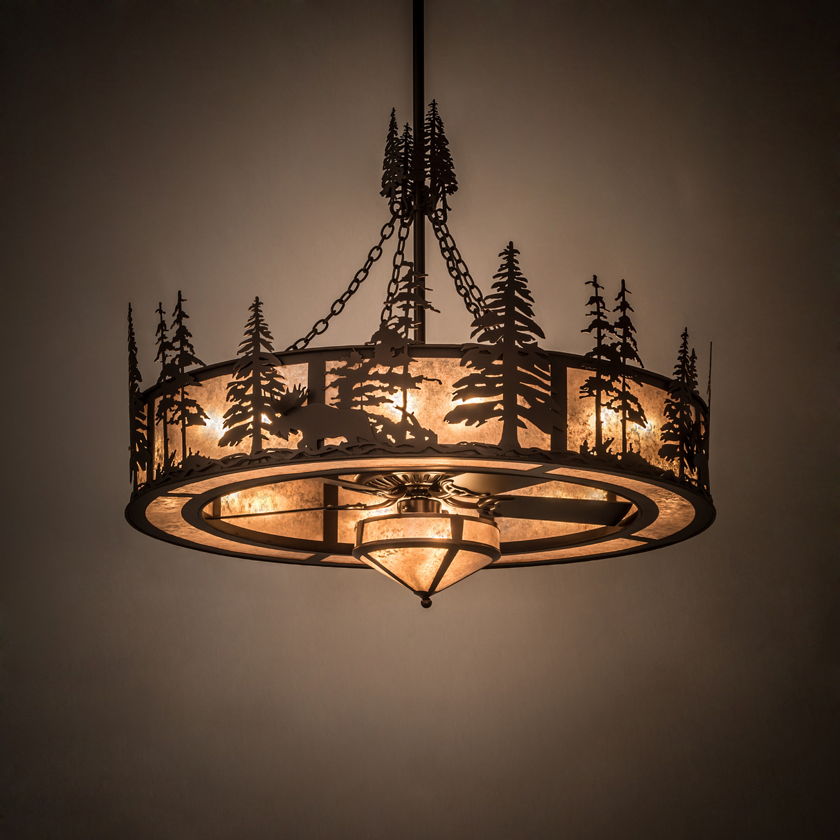 Moose at Dusk chandelier illuminated in room, casting a warm rustic glow.