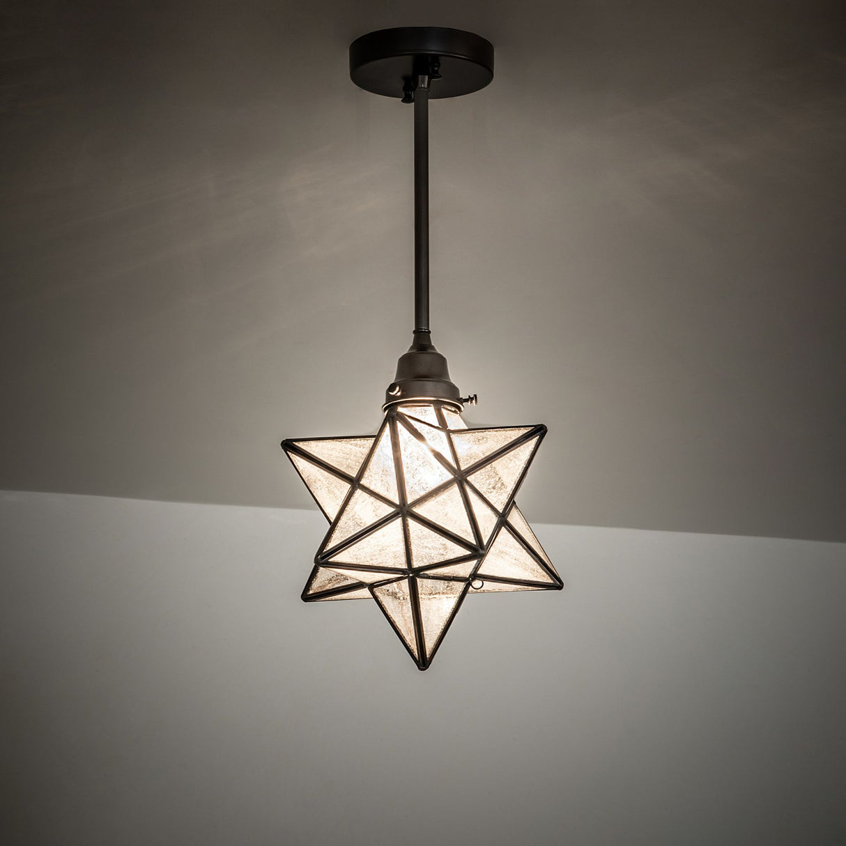 Ambient view of the Moravian Star Pendant, casting a soft glow on the ceiling.