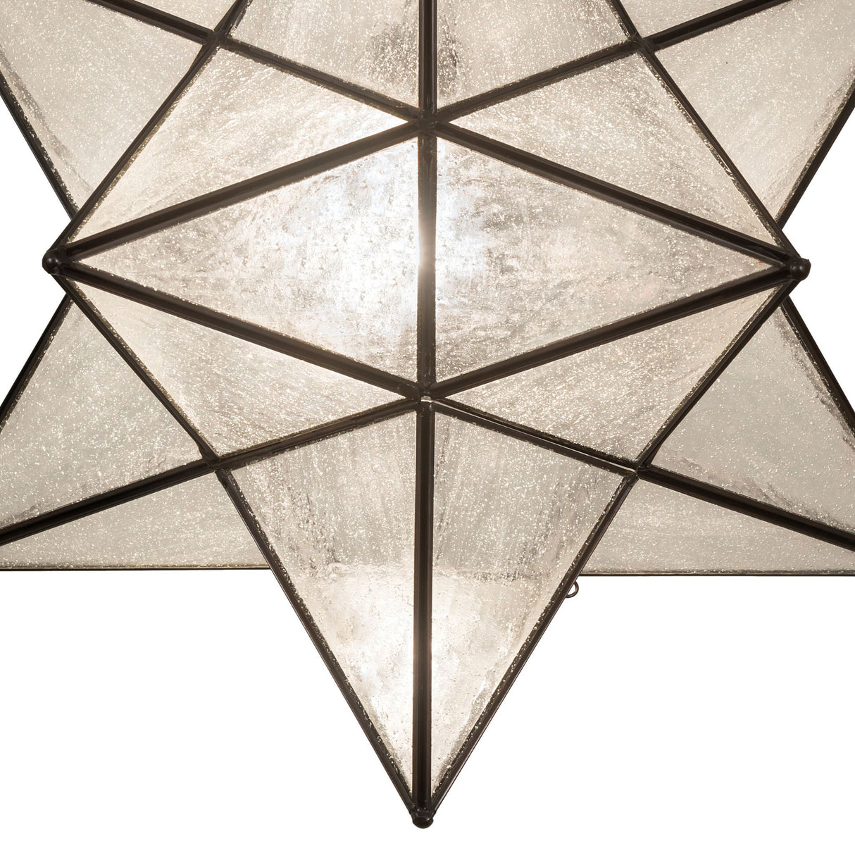 Close-up view of the Moravian star pendant’s brass construction and textured glass.