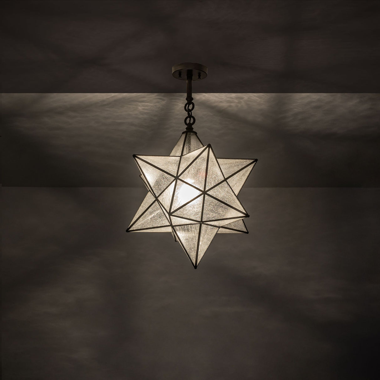 Illuminated Moravian star semi-flushmount casting elegant light patterns.