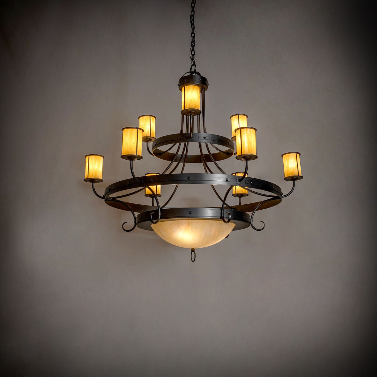 Nehring 9 light chandelier in ambient lighting with layered Botticino Idalight glass shades.