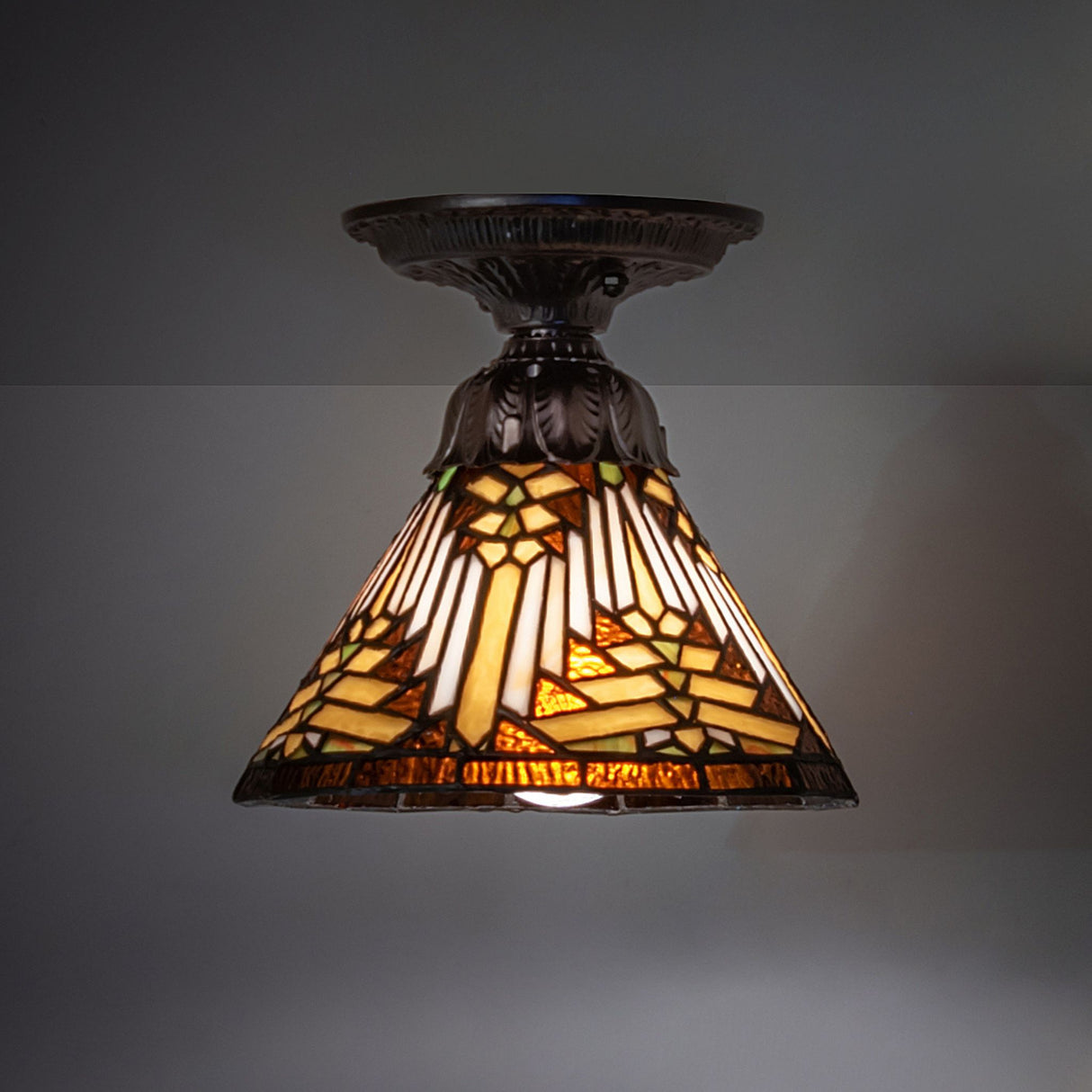 8" Nuevo Mission flushmount ceiling light with stained glass and a dark shade.