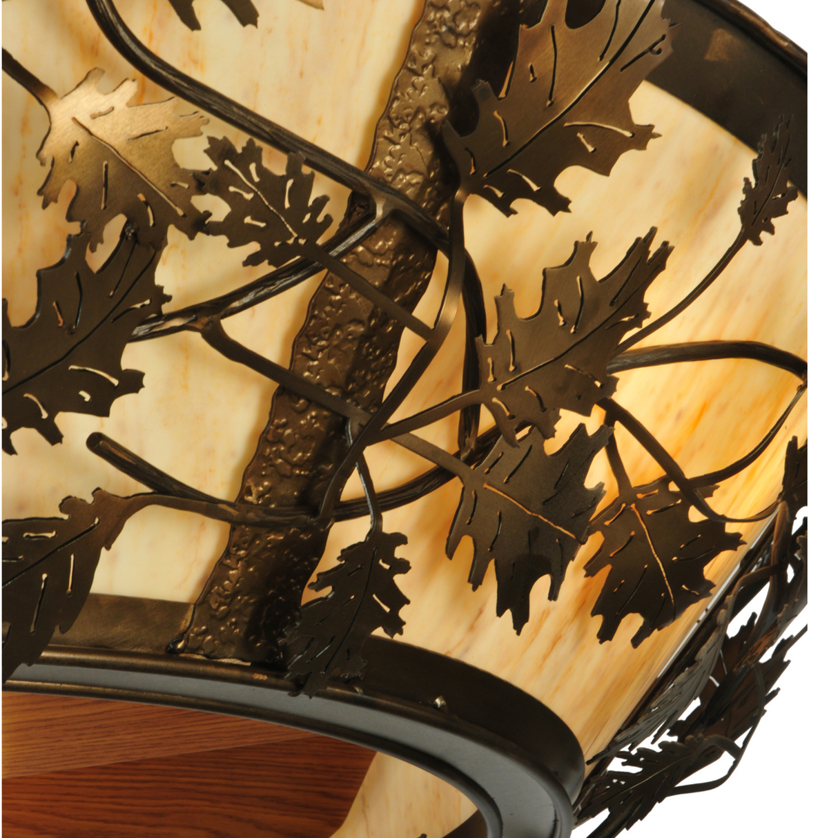 Close-up of oak leaf metal accents on amber diffuser.