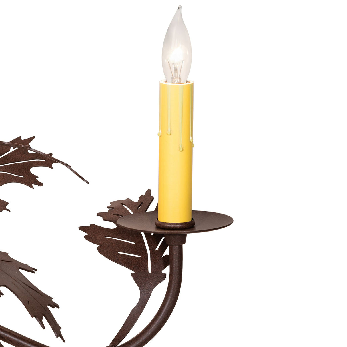 Close-up of candle socket showing yellow drip sleeve and leaf metalwork.