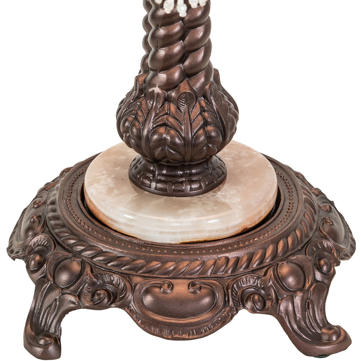 Close-up of ornate bronze base with marble inset detail.
