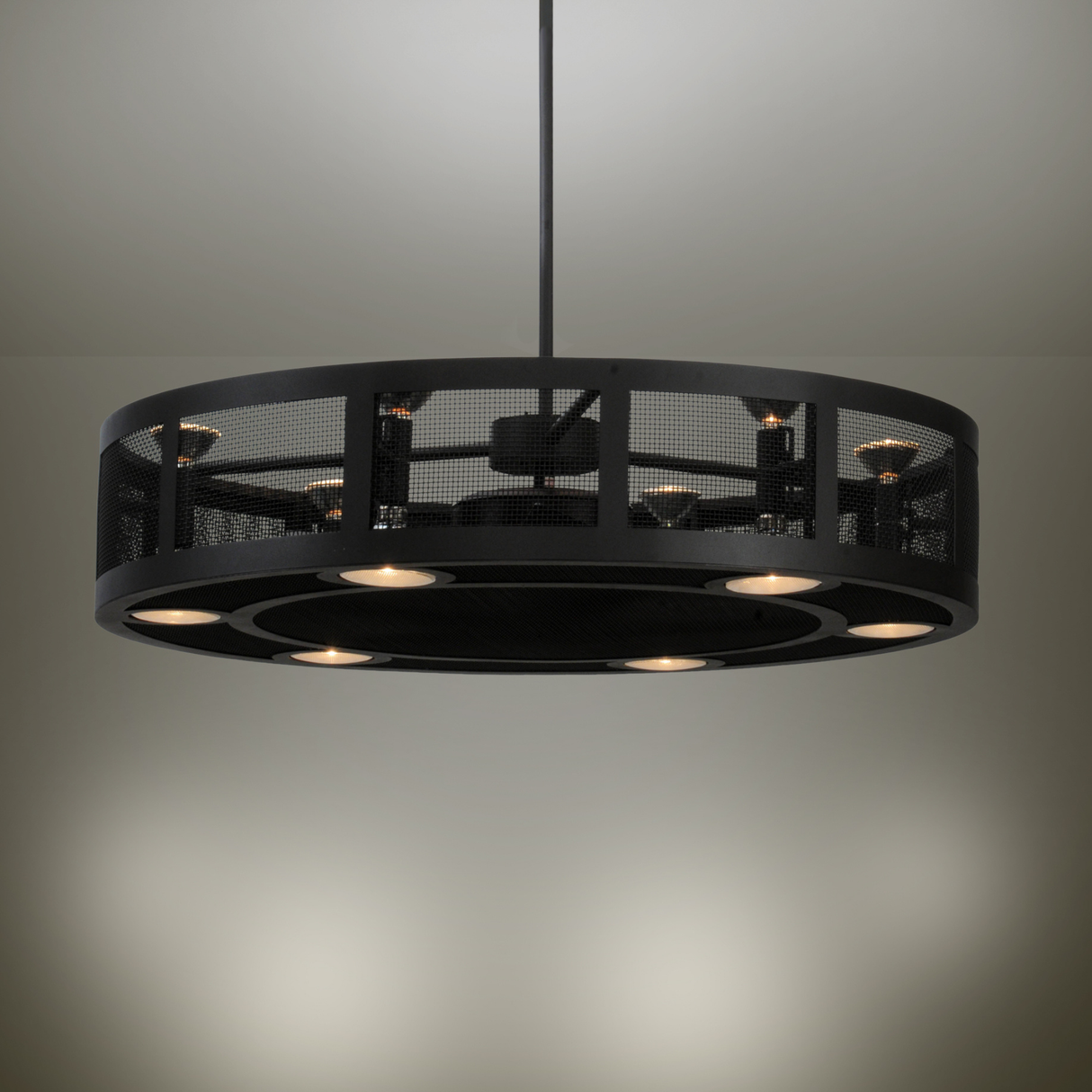 Illuminated Paloma Golpe Chandel-Air casting warm industrial glow on ceiling.