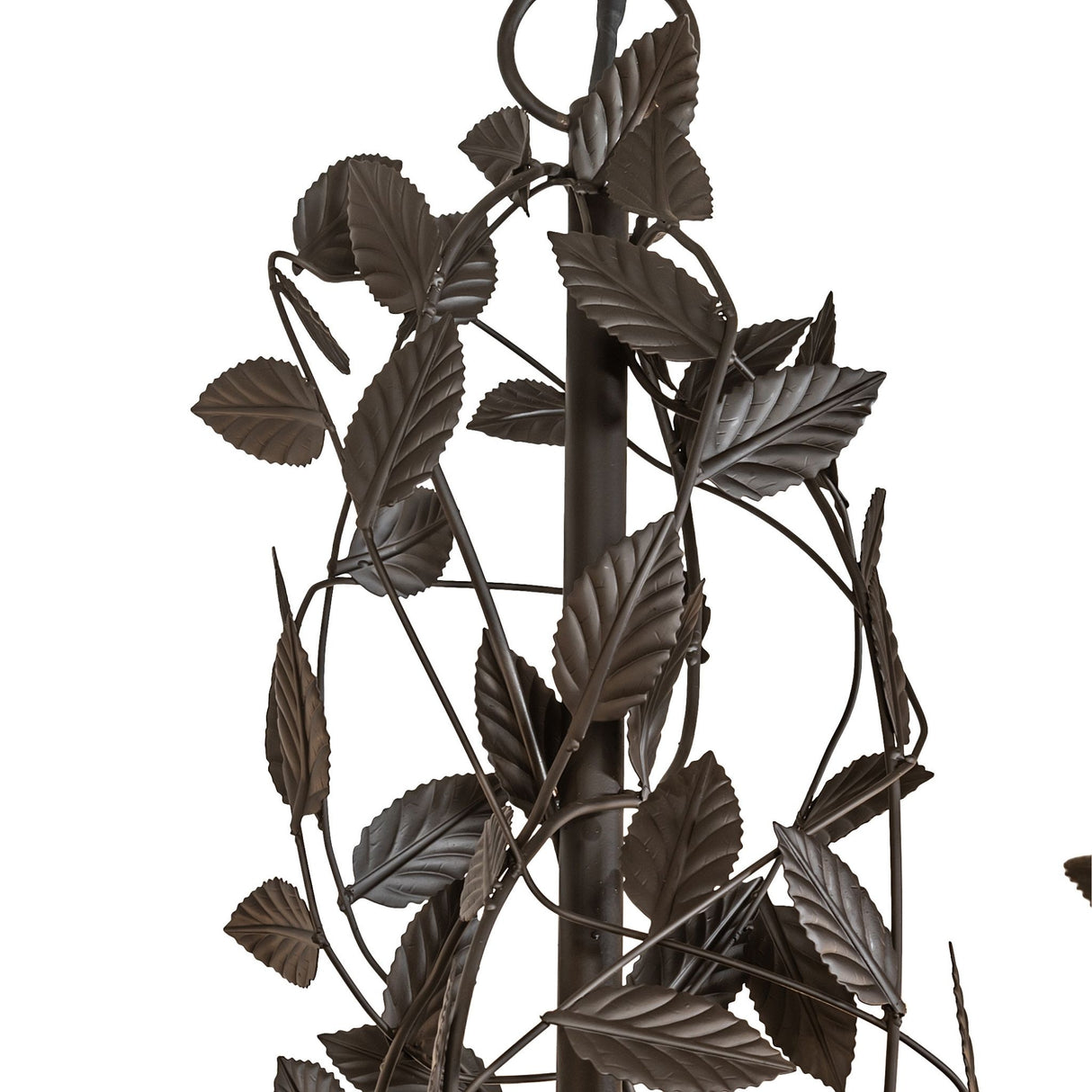 Closeup of leaf and branch scrollwork around candlelight holder.