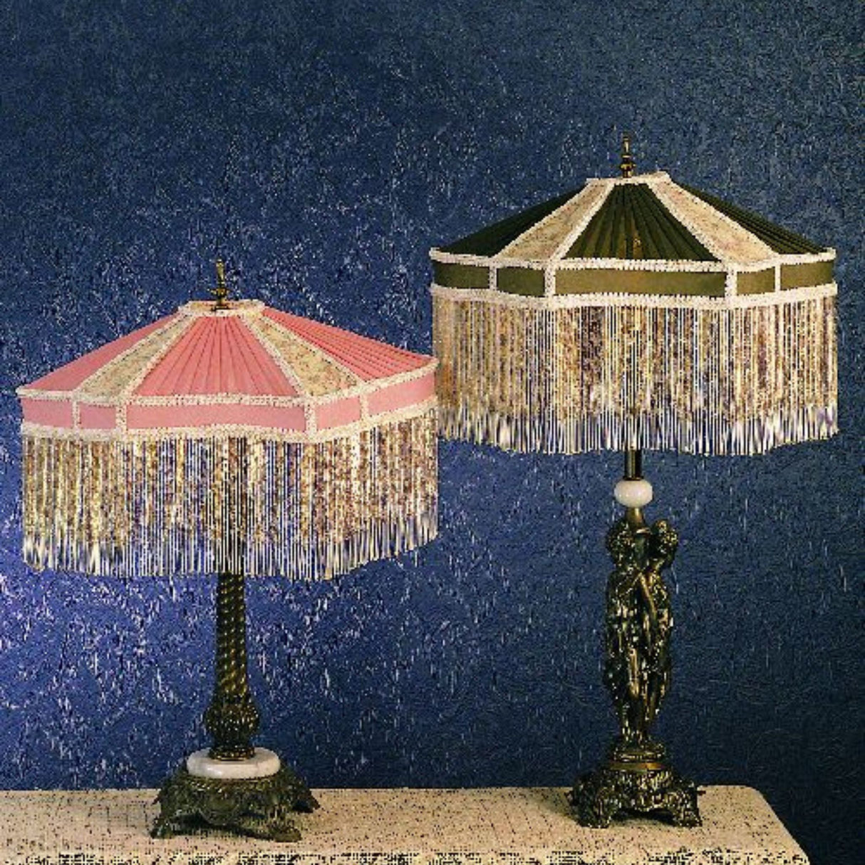 Close-up view of two Persian-style table lamps with decorative fabric shades and fringe trim.