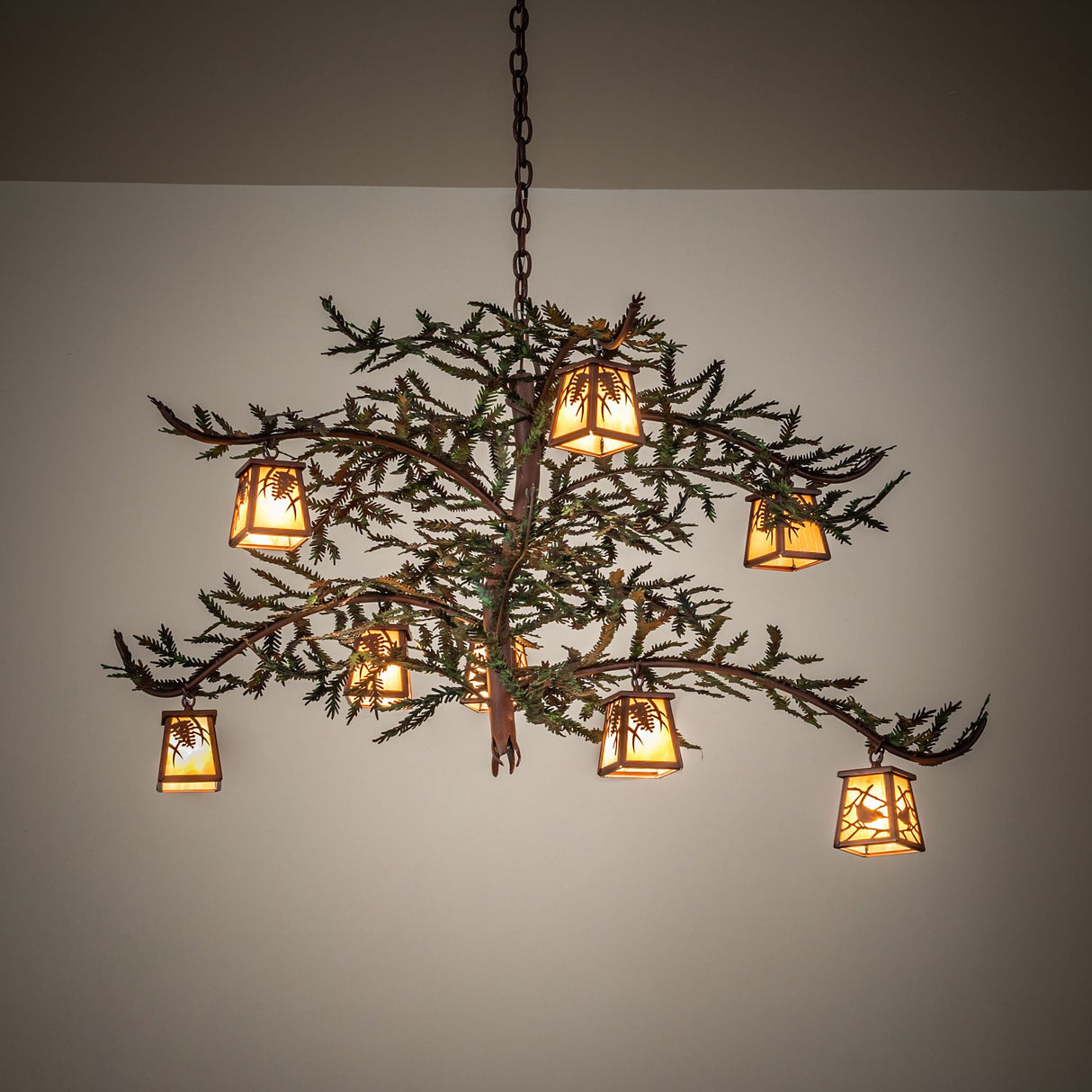 Ambient view of chandelier casting a warm glow through iridescent lantern shades.